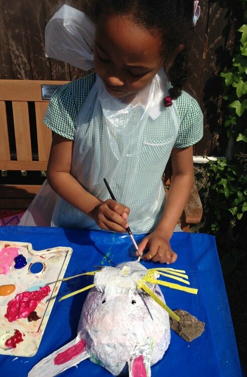 Zuza paints her rabbit mask.JPG