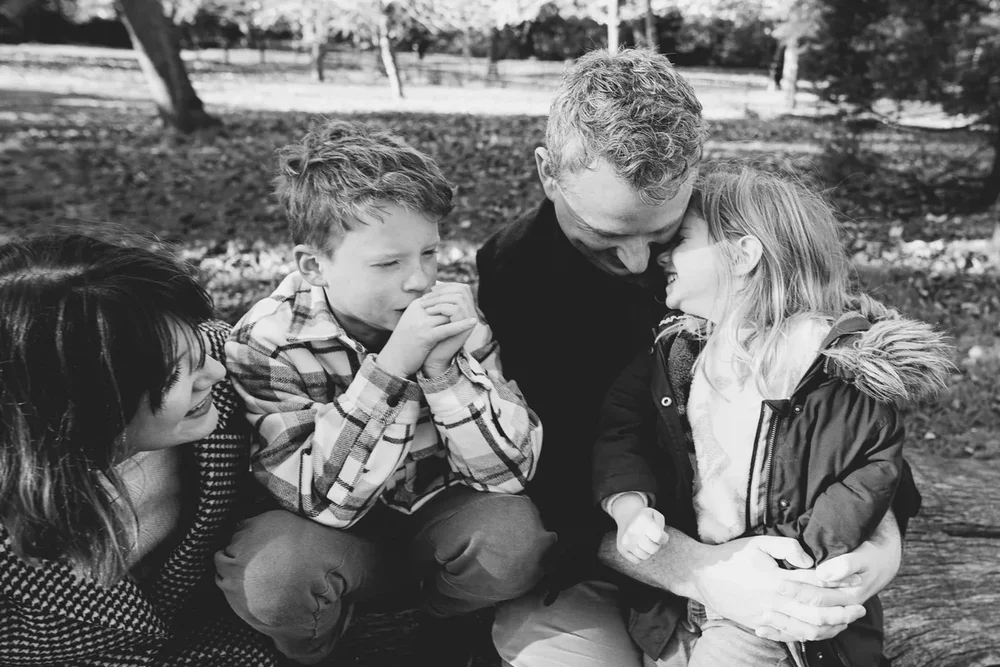 family-photographer-east-dulwich-london-candid-natural-family-portrait-taken-in-peckham-rye-park-london-lifestyle-family-photography-in-black-and-white.webp