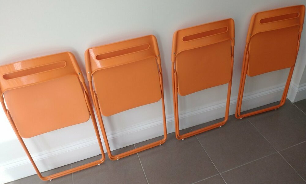 orange folding chairs folded.jpg
